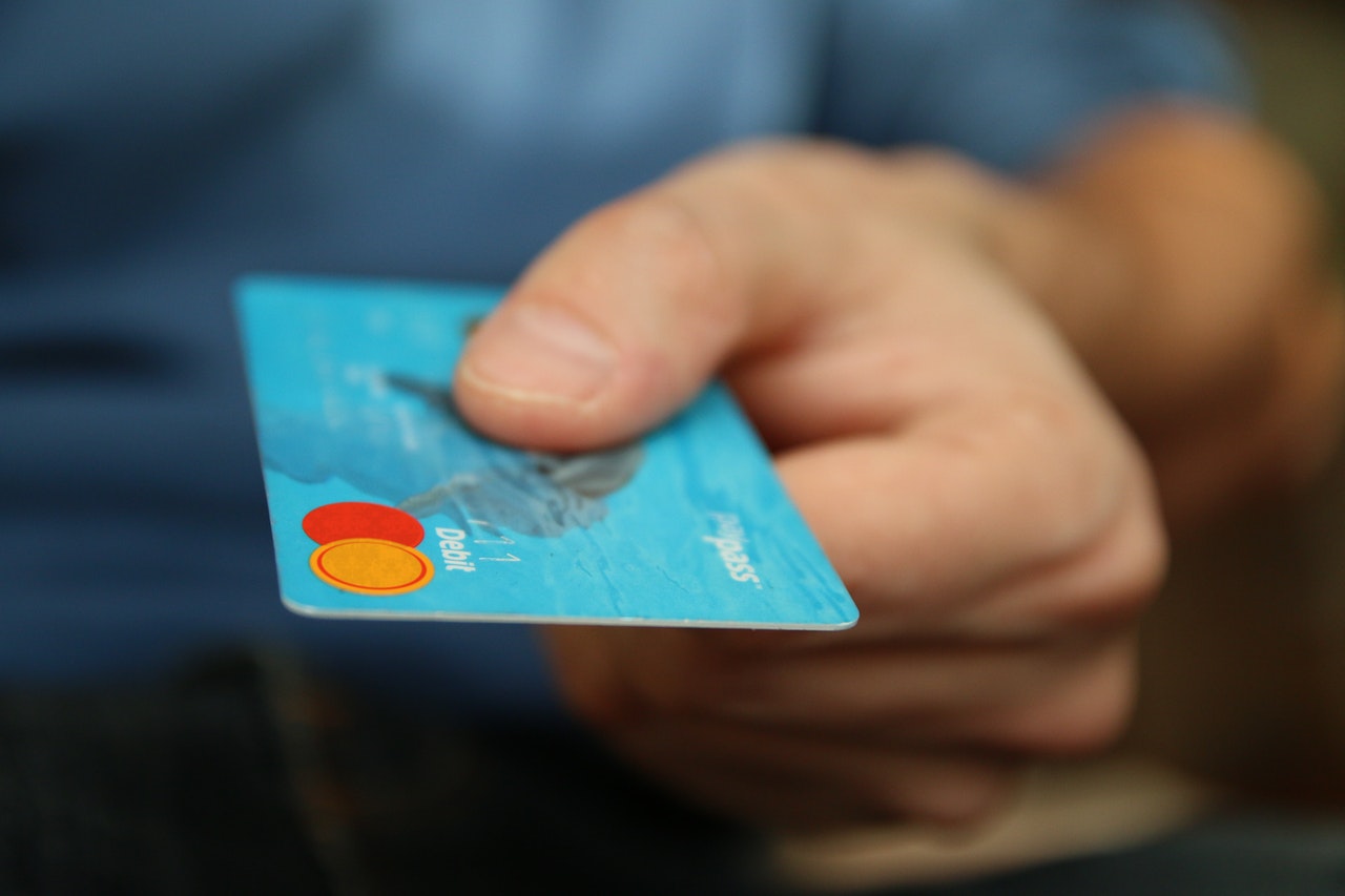 man holding a debit or credit card