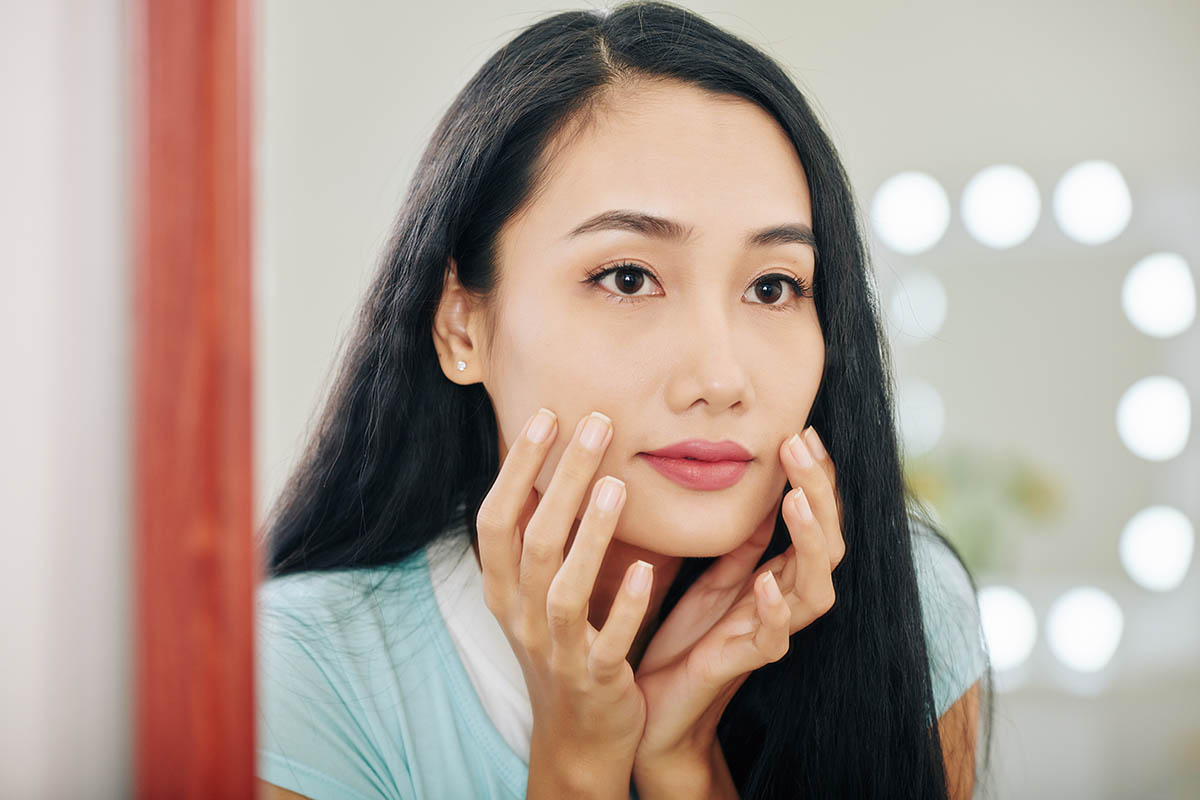 Woman looking at herself in mirror